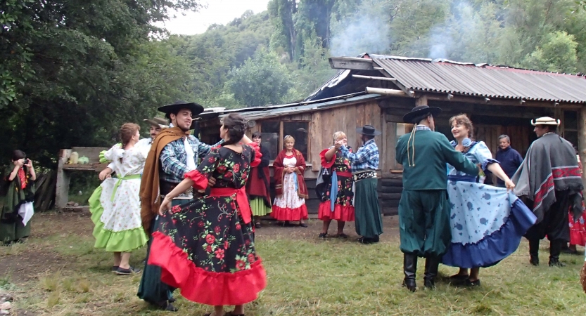 A group of people dance outdoors.